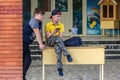 A boy and his friends sitting on the table and playing phone. Children and modern technologies.