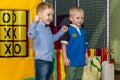 Children`s birthday celebration in the gaming complex. Group of kids having fun at playground. Royalty Free Stock Photo