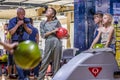 A girl holding bowling ball and going to throw it. Children having fun.