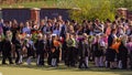 A group of people parents and children at a holiday on the first school day.