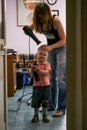 2010.06.12, Maloyaroslavets, Russia. Hairdresser dries little boy hair at salon.