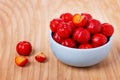 Malpighia glabra (red acerola), tropical fruit in bowl Royalty Free Stock Photo