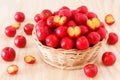 Malpighia glabra (red acerola), tropical fruit in wicker busket