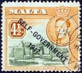 MALTA - CIRCA 1948: A stamp printed in Malta shows Mnajdra temple and King George VI Self-government 1947 overprint, circa 1948.