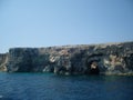 Malta coast limestone steep coastal slopes with geomorphological layers and caves Royalty Free Stock Photo