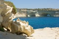 Malta east, rock arches over the sea, large stones and dry coast Royalty Free Stock Photo