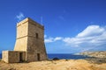 Malta - Ghajn Tuffieha watchtower at Golden Bay on a nice sunny day Royalty Free Stock Photo