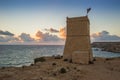 Malta - Ghajn Tuffieha watchtower at Golden Bay before sunset Royalty Free Stock Photo