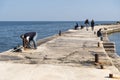 Relaxation on the breakwater in Bugibba, St Pauls Bay Malta Royalty Free Stock Photo