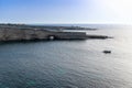 Malta, Marsaxlokk, August 2019. Lonely yacht in the large blue lagoon.