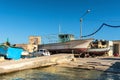 Malta, Marsaxlokk, August 2020. Vintage fishing boats being repaired on the shore.