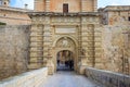 Malta, Mdina entrance gate. Tourists cross the footbridge to visit the historic fortified town. Royalty Free Stock Photo