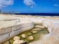 Malta\'s coastline reveals dramatic limestone cliffs and serene rock pools shaped by centuries of wind and waves Royalty Free Stock Photo