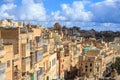 Malta, Valletta. Capital with tall traditional limestone buildings, under a blue sky with few clouds. Royalty Free Stock Photo