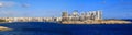 Malta, Valletta. Sliema town with multistorey buildings, blue sea and blue sky with few clouds background. Panoramic view, banner. Royalty Free Stock Photo