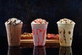 Malted milkshakes of different flavors and crepes. Dark background Royalty Free Stock Photo