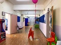 Corridor of an public kindergarten school and open doors and balloons around for educating students children schooling learning