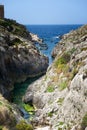 Maltese coastline with the cliffs,gold rocks over the sea in the Malta island with the blue clear sky background,Malta, nice bay Royalty Free Stock Photo