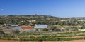 Maltese countryside in sunny winter day with vegetable greenhouses and arable land for growing crops