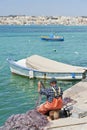 Maltese fisherman repairing his nets