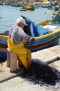 An old fisherman at work Malta