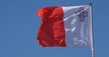 Maltese Flag Waving in the Wind against blue sky Royalty Free Stock Photo