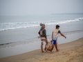 Indian fishermen carrying freshly catch fish at Malvan beach at morning