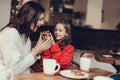Mama and daughter heaving breakfast in cafe Royalty Free Stock Photo