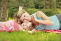 Mama and her little daughter lie on the grass Royalty Free Stock Photo