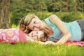 Mama and her little daughter lie on the grass Royalty Free Stock Photo