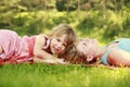 Mama and her little daughter lie on the grass Royalty Free Stock Photo