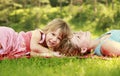 Mama and her little daughter lie on the grass Royalty Free Stock Photo