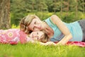 Mama and her little daughter lie on the grass Royalty Free Stock Photo