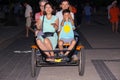 Group of friends riding a quadricycle together in the evening Royalty Free Stock Photo