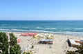 Beach of Black Sea with golden sands, sun umbrellas, sunbeds, blue clear water, bars and hotels. Royalty Free Stock Photo