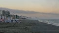 Beach of Black Sea from Mamaia, Romania with sunbeds and umbrellas, foggy day. Royalty Free Stock Photo