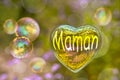 Maman (meaning mom in French) written on a soap bubble in the shape of heart