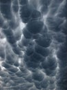 Dark sky by Mammatus clouds in pouch-like shapes