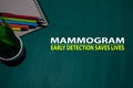 Mammogram - Early Detection Saves Lives Text on Table Green Background