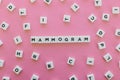 Mammogram word made of square letter word on pink background.