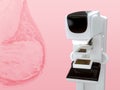 Mammography device for screening breast cancer in hospital on pink background.