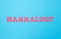 Mammology word in red letters on a blue background. Concept is a section of medicine dealing with the treatment and prevention of Royalty Free Stock Photo