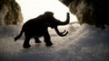 Mammoth on a background of ice. Figurine of a mammoth in a snowy landscape. Mammoth, mammoth frozen in ice