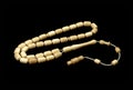 Mammoth tusk prayer beads perspective view isolated on black