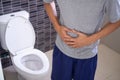 Man abdominal pain and constipation in the bathroom. Concept of health problems, stomach, diarrhea Royalty Free Stock Photo