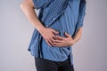 Man with abdominal pain, stomach ache on gray background Royalty Free Stock Photo