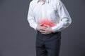 Man with abdominal pain, stomach ache on gray background Royalty Free Stock Photo