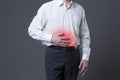 Man with abdominal pain, stomach ache on gray background Royalty Free Stock Photo