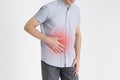 Man with abdominal pain, stomach ache on gray background Royalty Free Stock Photo