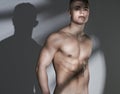 Man, abs and muscle in studio portrait, shirtless or confident for healthy body by white background. Person, topless